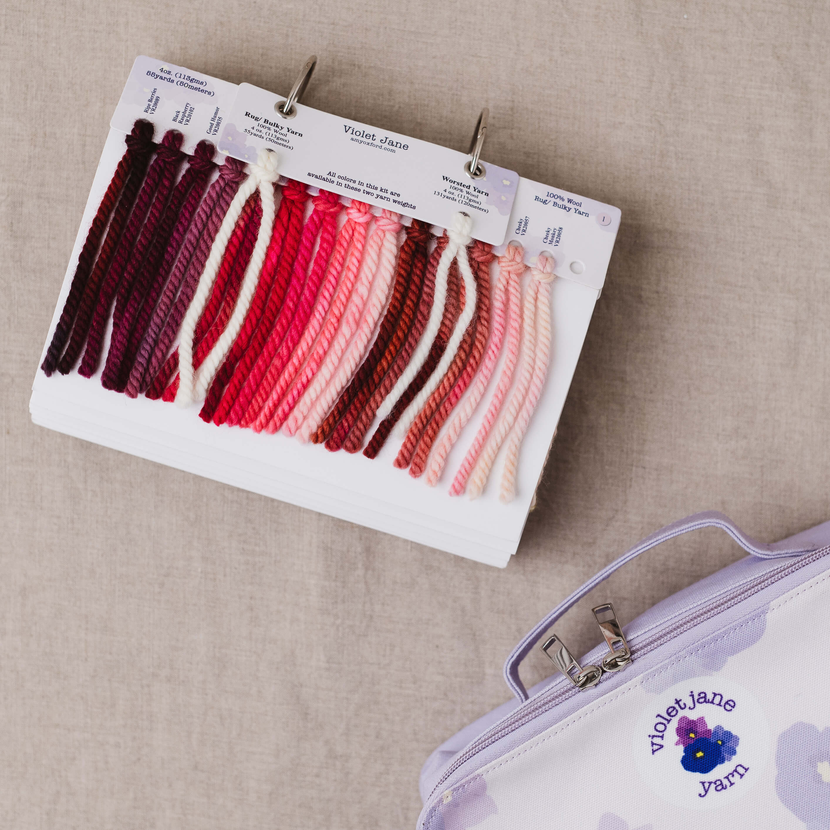 Color swatch card with yarn samples and a Violet Jane jar on a beige background