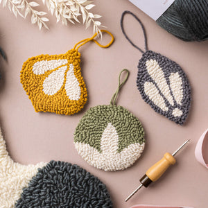 Classic punch needle bauble decorations lying flat on a table top