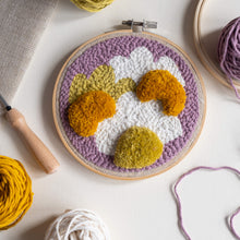 Load image into Gallery viewer, Punch needle and tufted daisy hoop laying flat with punch needle, yarn and fabric coming into focus around edge
