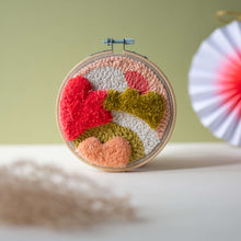 Load image into Gallery viewer, Dunes punch needle hoop stood up styled with dried flowers in the foreground and a white paper decoration in the background