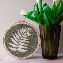 Load image into Gallery viewer, Finished fern punch needle hoop wall hanging next to a vase of tulips