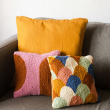 Load image into Gallery viewer, Scallop punch needle cushion with shapes cushion and tan cushion propped on sofa