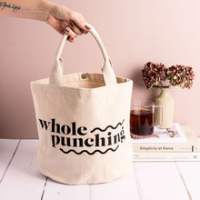 Load image into Gallery viewer, Hand holding the handle of a Whole Punching cotton project bag