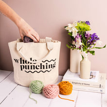 Load image into Gallery viewer, Hand pulling yarn out of a Whole Punching cotton project bag