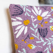 Load image into Gallery viewer, Lilac punch needle floral cushion propped against a pink velvet chair with a light cream cushion